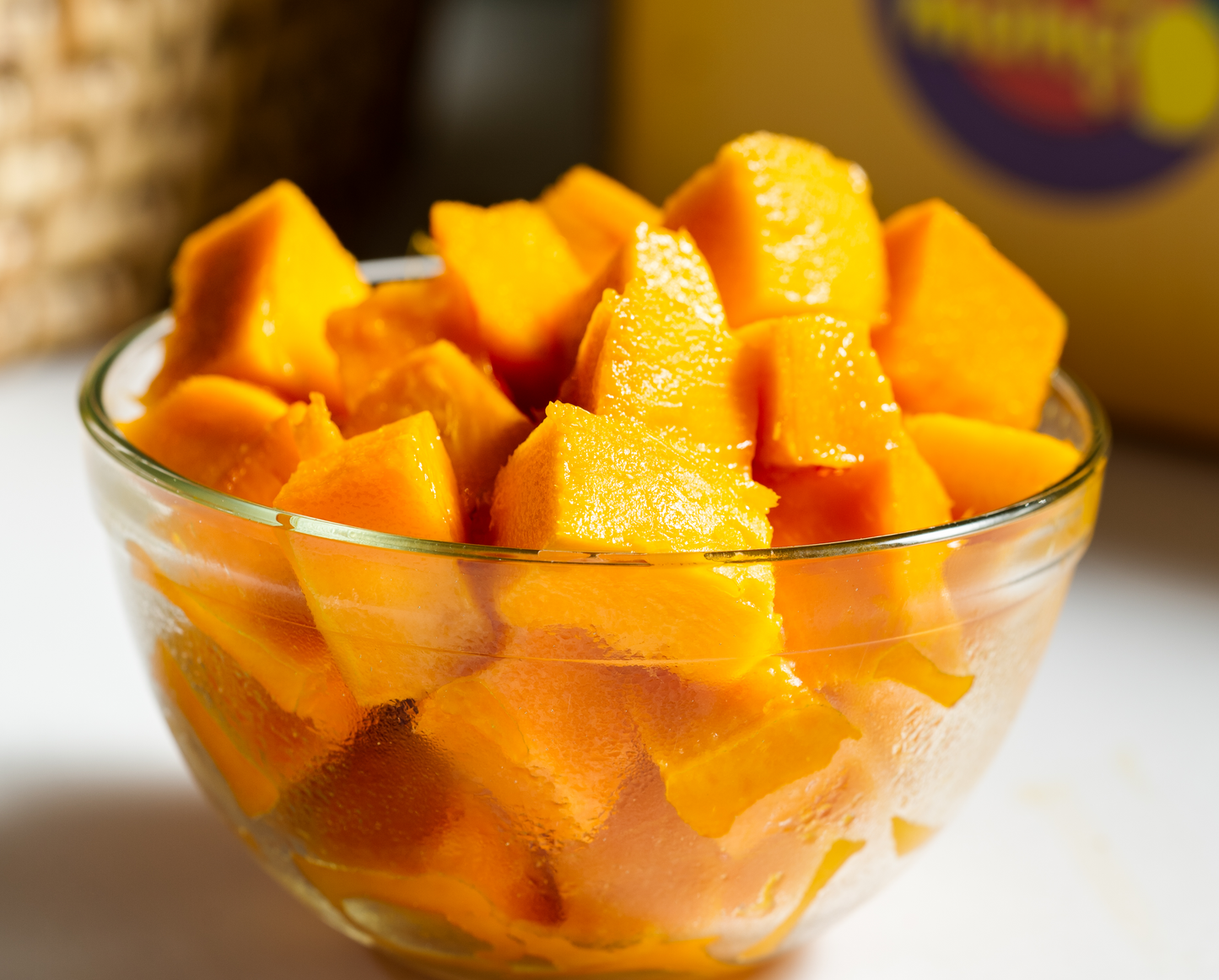 Close-up of fresh, ripe mango chunks served in a glass bowl. hapus mango online