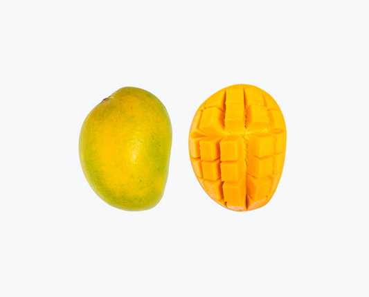 An image of two Alphonso mangoes, one intact and the other cut open to show the flesh and seeds inside. order alphonso mangoes online