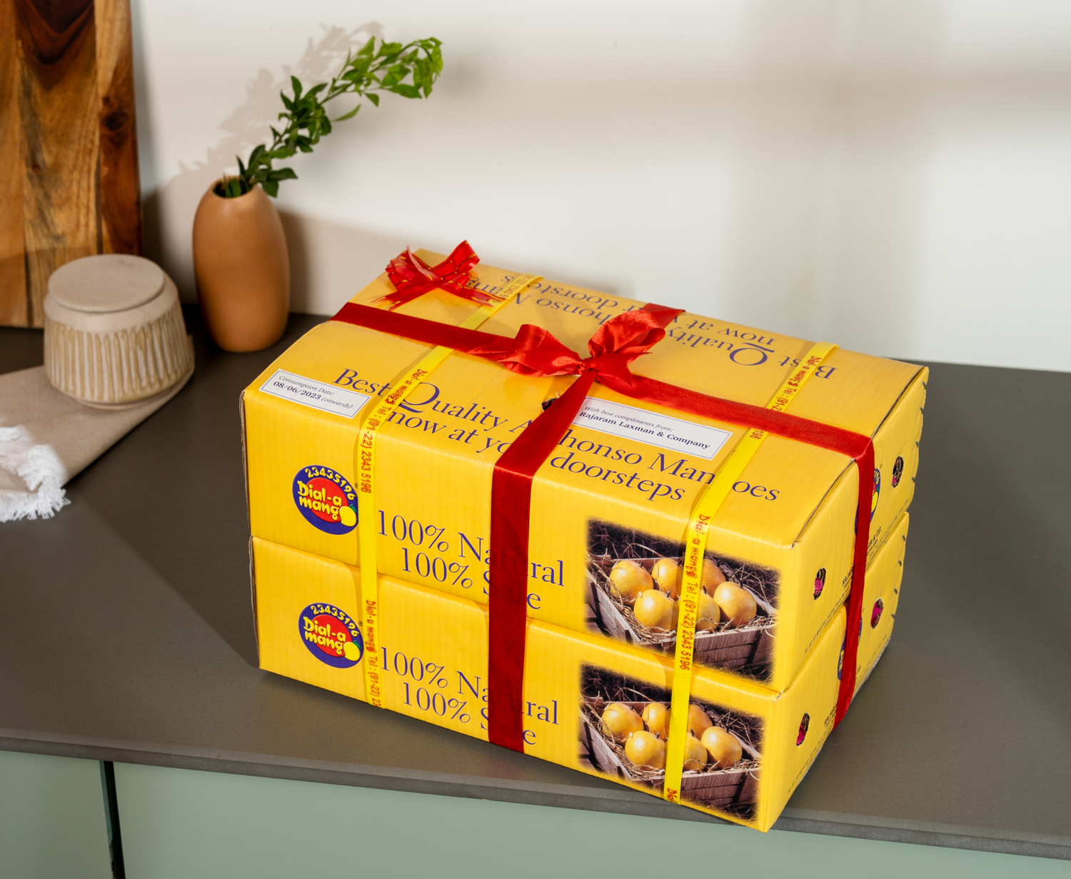 Gift wrapper of box of naturally ripened mango placed on a clean countertop. buy alphonso mangoes online
