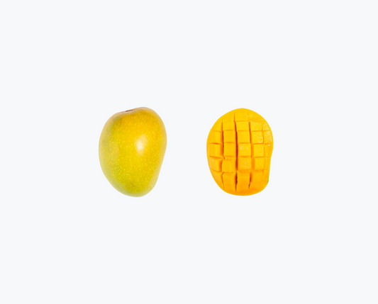 An image of two mangoes, one whole and the other cut into pieces showing the flesh and seeds. buy alphonso mangoes online India
